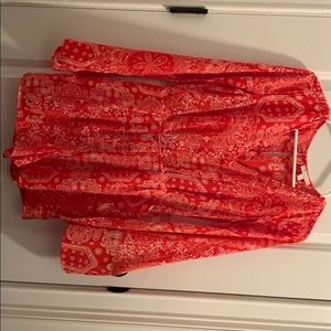 A red and white romper with open slit arms.